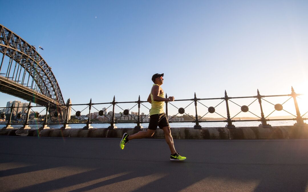 man in yellow tank top running near shore